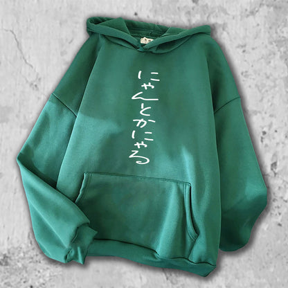 にゃんとかにゃる、とプリントされたＴシャツのグリーン